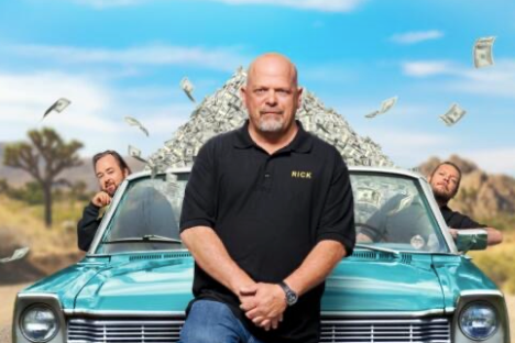 Rick Harrison standing in front of a car posing for the camera